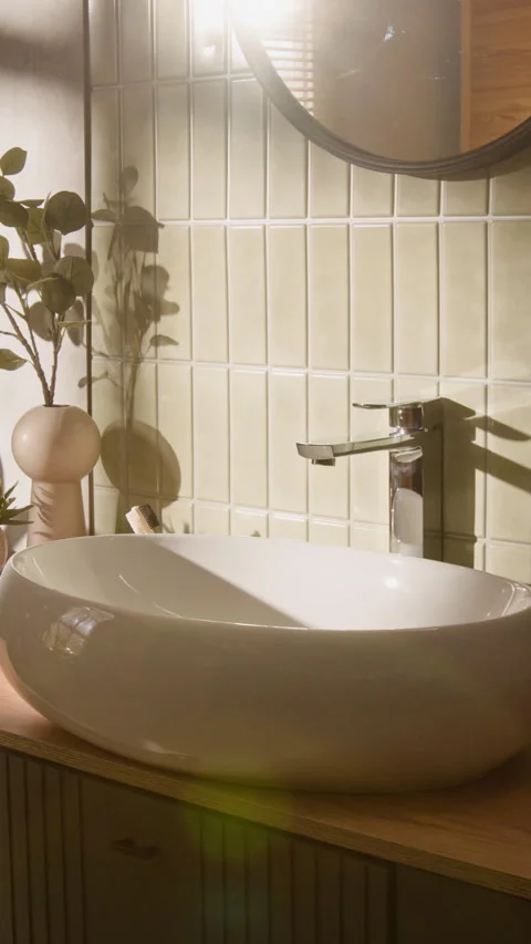 Vertical of Modern Bathroom Interior with Vessel Sink Gleaming in Sunlight Stock Footage 342725270
