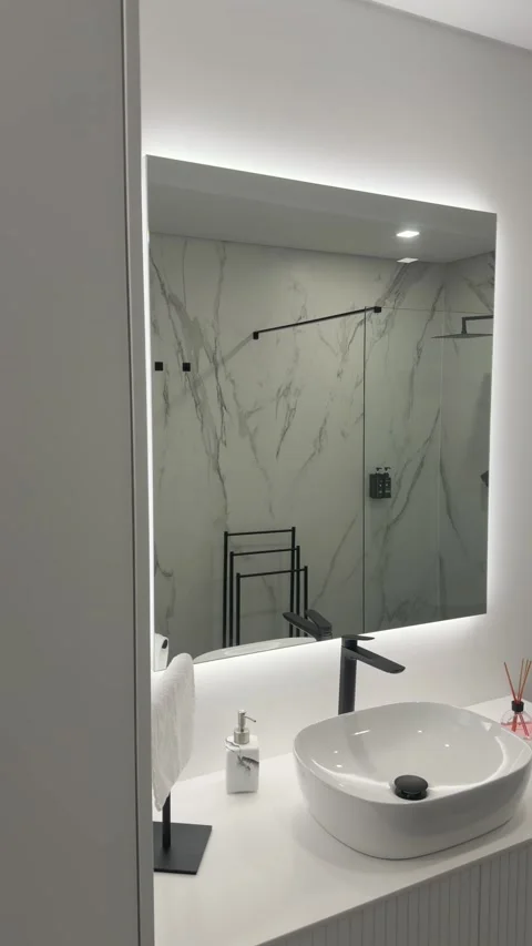 Vertical modern bathroom vanity with sink and backlit mirror Stock Footage 328685587