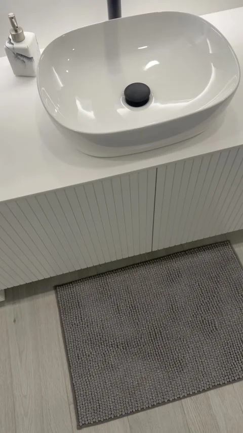Vertical modern bathroom vanity with white sink and black faucet Stock Footage 328685606