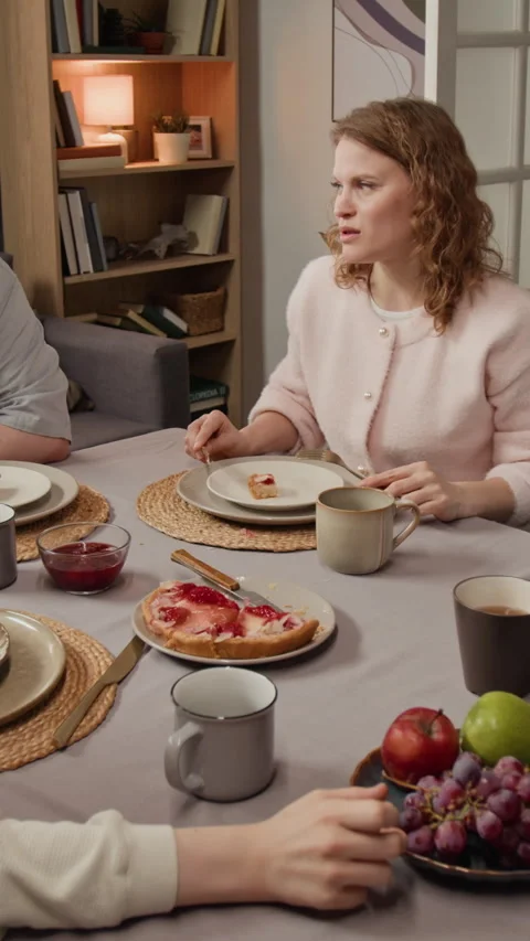Vertical of Mother Having Breakfast and Talking with Family at Dining Table Stock Footage 340322937