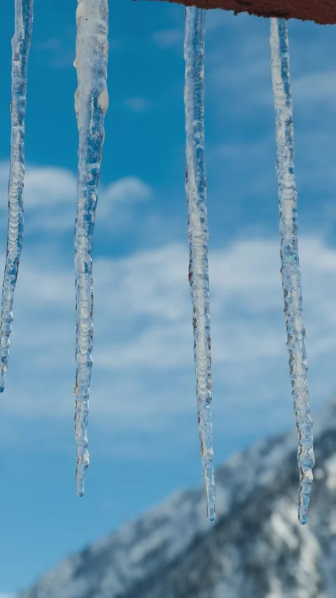 Vertical motion controlled timelapse of melting icicles Stock Footage 327827154