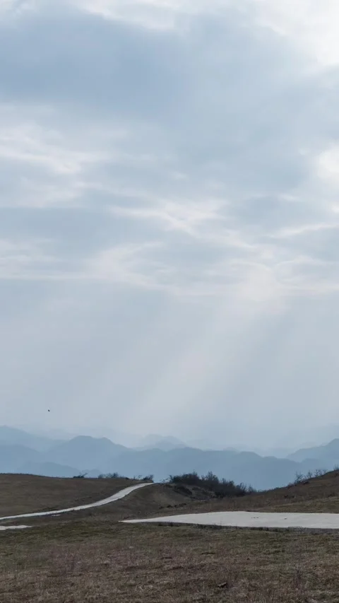 Vertical Mountain Peak Clouds Timelapse with Sunset Glow and Flowing Sky Stock Footage 327600046