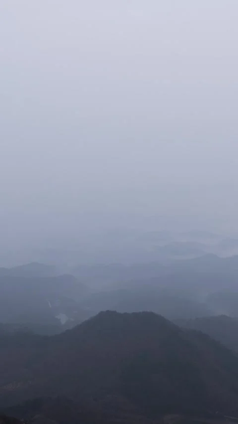 Vertical Mountain Top Mist and Fog Timelapse with Rolling Clouds Nature Vista Stock Footage 327478592