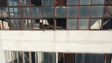 Vertical movement of the camera along the walls of an abandoned factory with Stock Footage 161145210