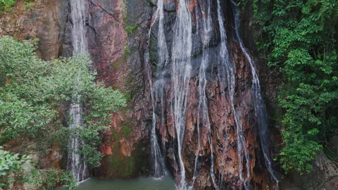 Vertical movement of drone along tropical waterfall. Stock Footage 331836416