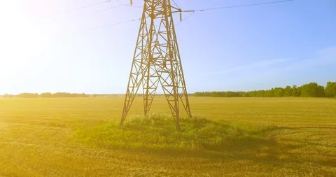 Vertical movement flight near high voltage electricity tower and power lines at Stock Footage 115077989