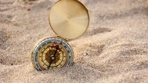 Vertical movement of golden compass on the sand Stock Footage 287437632