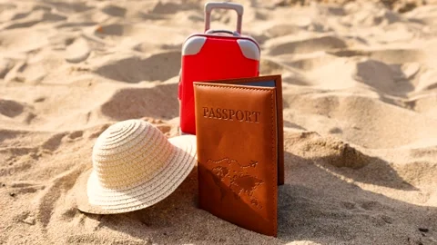 Vertical movement of passport, straw hat and suitcase on the sand Video stock 287180448