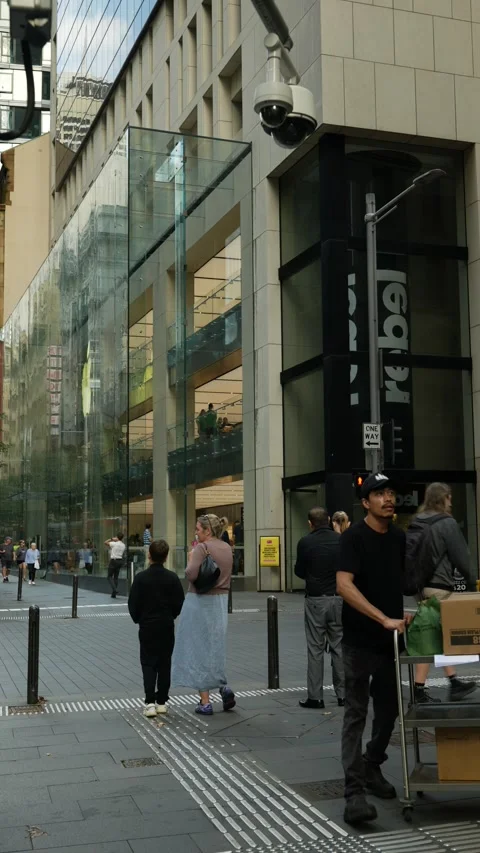 Vertical moving merchandise through Sydney street and CCTV camera 6K Video stock 308155394