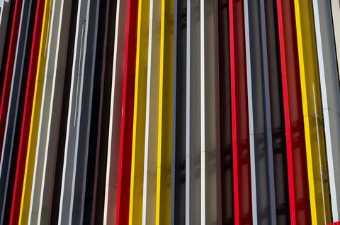 Vertical multi-colored stripes in the design of a shop window fragment. Stock Photos