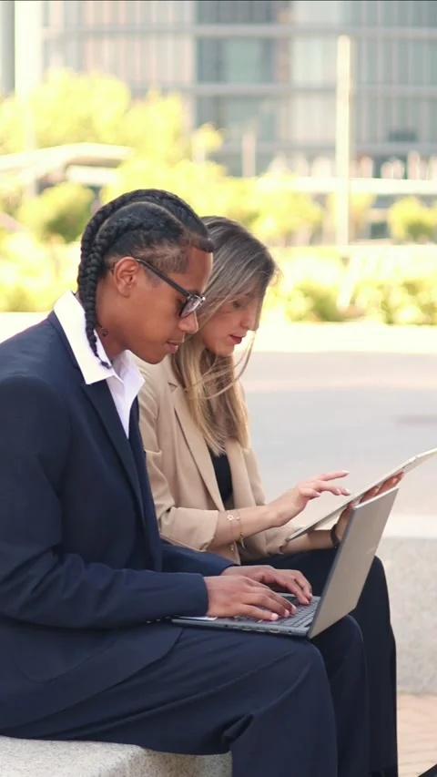 Vertical multiethnic Business partners working outdoor using laptop and table Stock Footage 317014396