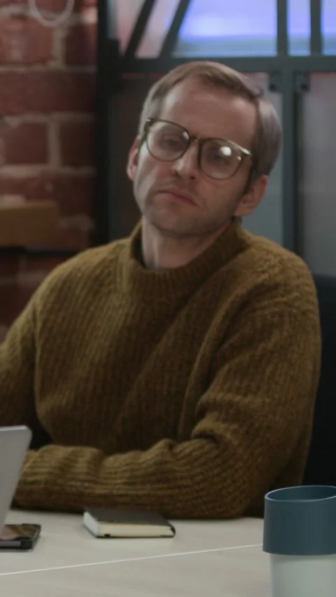 Vertical of Multiethnic Developers Discussing Program Coding on Laptop in Office Stock Footage 319994560