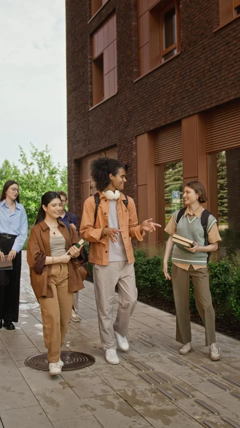 Vertical of Multiethnic Group of Students Walking on University Campus Stock Footage 342124761