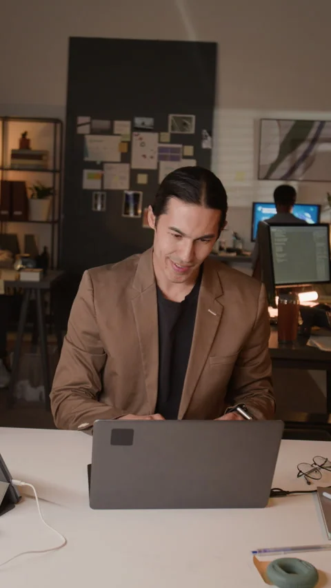 Vertical of Multiethnic Office Team Celebrating Success Looking at Laptop Screen Stock Footage 336715240