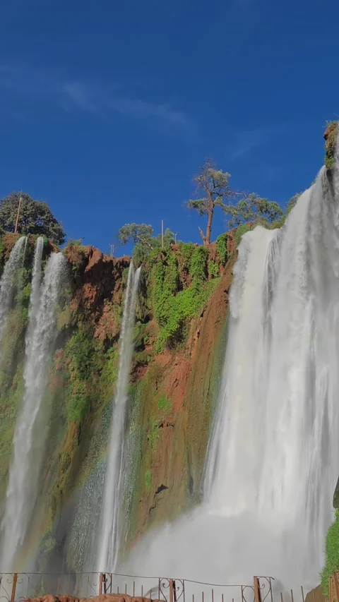 Vertical - multiple cascades of Ouzoud Falls over red cliff in Morocco Stock Footage 344511131