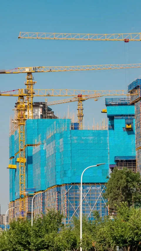 Vertical multiple tower cranes work on construction site to build buildings. 動画素材 336038380