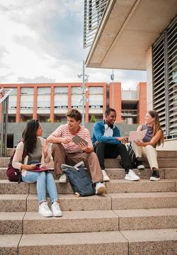 Vertical multiracial group of students sitting on the university campus Stock Photos