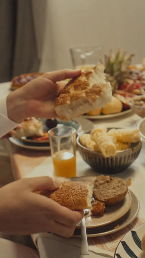 Vertical of Muslim Sharing Pita Bread with Family During Eid Dinner Stock Footage 266413357