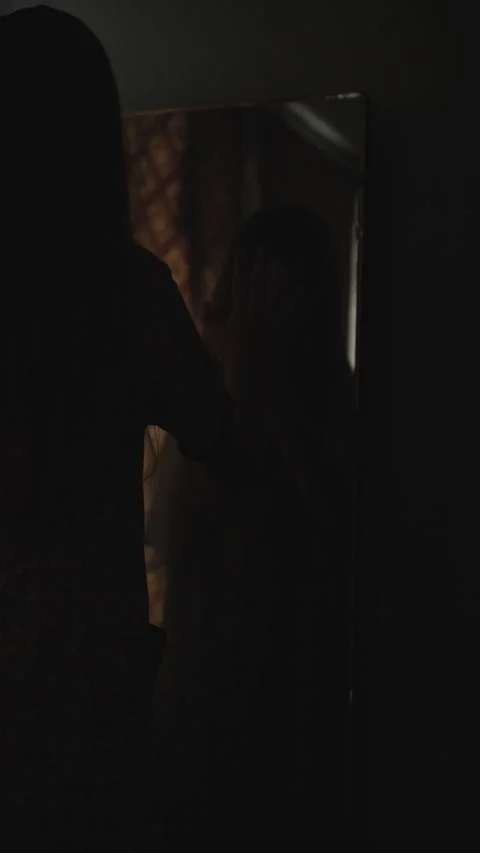 Vertical Mysterious Female Figure Reflected in Mirror During Nighttime Horror Video stock 320164234