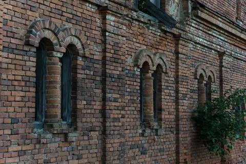 Vertical, narrow windows of a brick stable. 19th century building Stock Photos