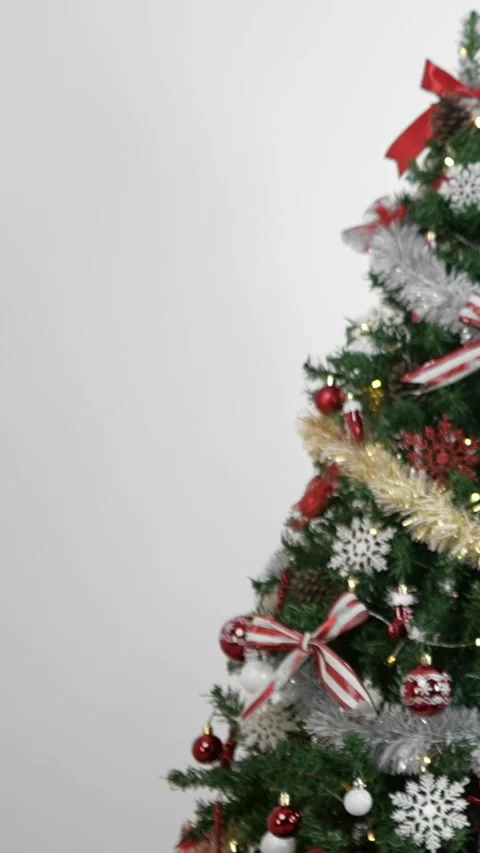 Vertical Neatly wrapped gift boxes beneath contemporary Christmas tree in home Stock Footage 316489129
