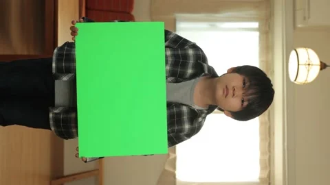 Vertical : Neglected young boy holding green board. Chromakey editing. 25P. Stock Footage 221357142