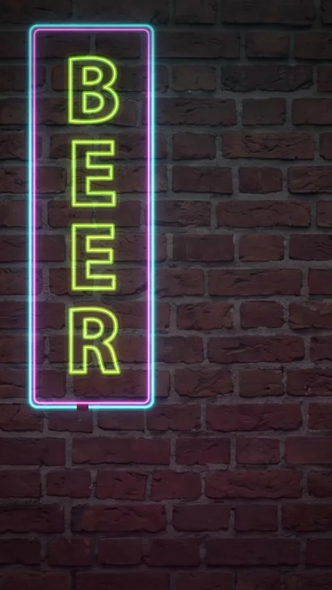 Vertical Neon Beer Sign Flickering on a Red Brick Wall Background Stock Footage 339836348