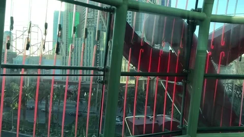 Vertical neon lights down Coca Cola elevator overlooking Las Vegas strip Stock Footage 84014924