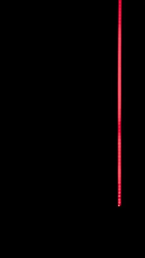 Vertical neon red light streams cascade down through dark futuristic corridor Stock Footage 345102738