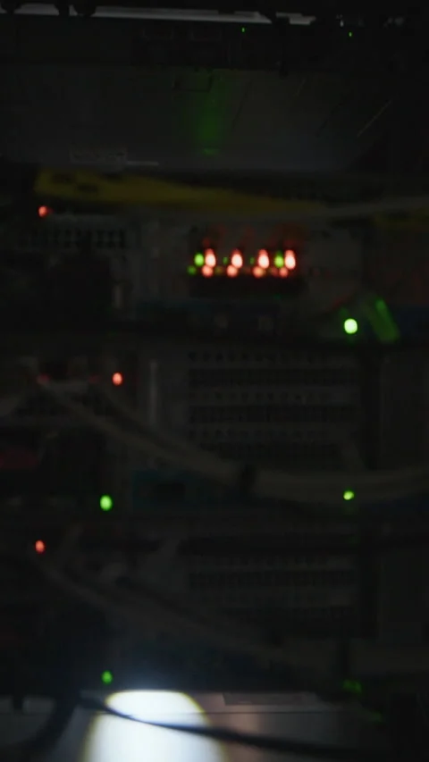 Vertical of Network Engineer Opening Rack and Checking Hardware with Flashlight Stock Footage 330541100