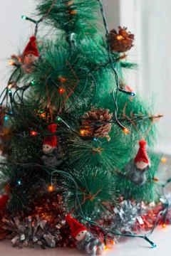 Vertical New Year composition. Decorated Christmas tree with colorful garland Stock Photos