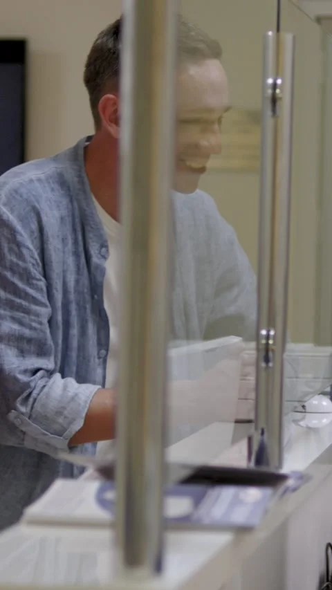 Vertical. nice couple in a hospital, casually interacting at the reception desk Stock Footage 294068588