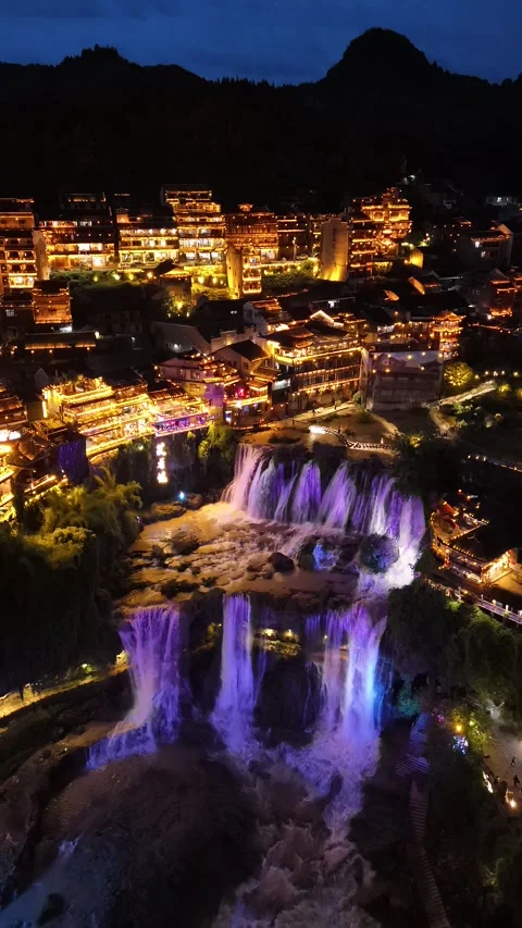 Vertical Night Drone View of Furong Ancient Town and Colored Waterfall Stock Footage 333682623