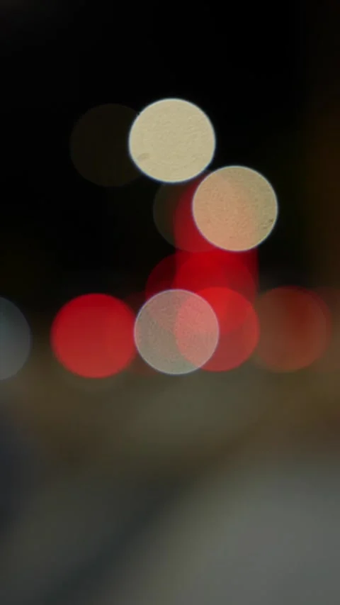 Vertical night frame filled with glowing bokeh circles from vehicle headlights Stock Footage 330663038
