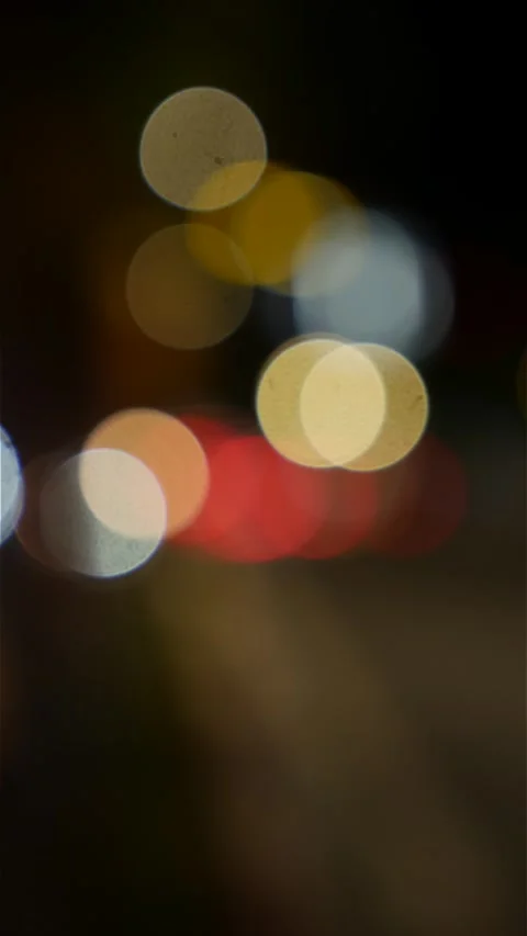 Vertical night scene with headlights and taillights blending into luminous bokeh Stock Footage 331943881