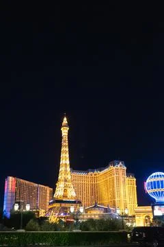 Vertical night shot of the Eiffel Tower in front of the Paris Hotel and Casino Stock Photos