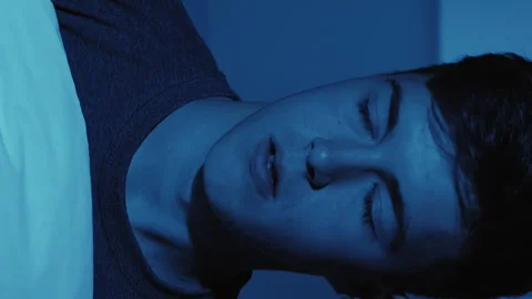 Vertical night terror sleep disorder guy in bed Stock Footage 288745001