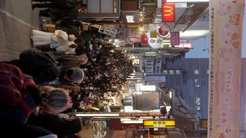 Vertical night time street view of Harajuku walking street shopping area in.. Video stock 329673815
