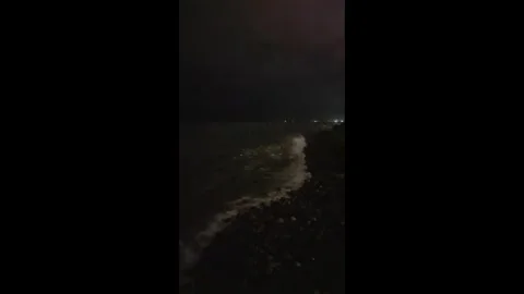 Vertical Night Waves with Distant Lights Black Sea 4K – Mute Vidéo 331239097