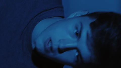 Vertical Nighttime Shadow Hand Scared Guy sleeping Stock Footage 288794797
