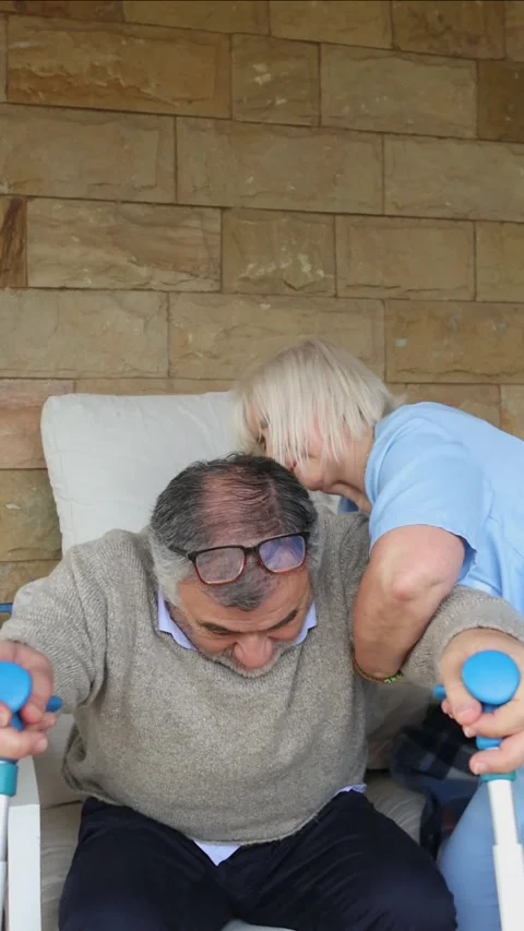 Vertical Nurse assisting elderly man getting up from wheelchair Stock-Footage 300172205