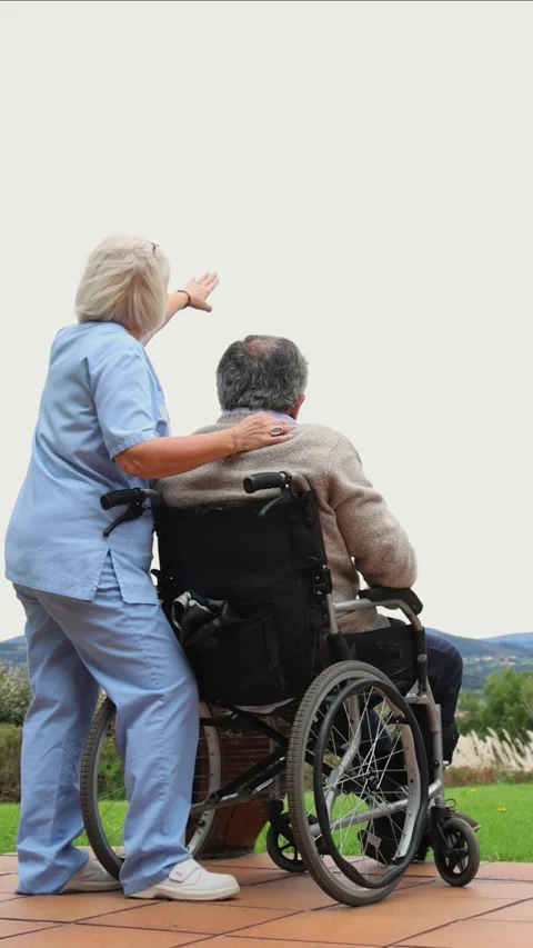Vertical Nurse assisting elderly man in wheelchair pointing at the landscape Stock Footage 300172222