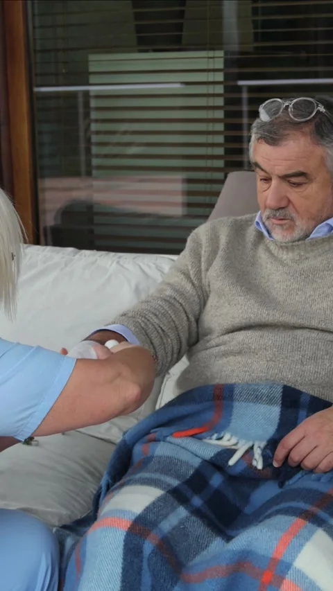 Vertical Nurse bandaging elderly man's arm Stock Footage 300172212