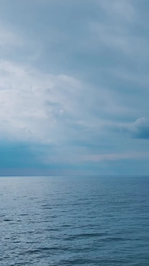 Vertical ocean horizon under dramatic sky with soft lighting Stock Footage 341831116