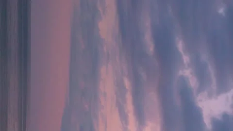 Vertical, Ocean Orange Pink Sunset Sky with Rain Purple Cumulus Clouds Time Laps Stock Footage 317563217