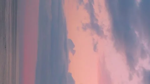 Vertical, Ocean Orange Pink Sunset Sky with Purple Rain Plump Clouds, Beautiful  Video stock 317563267