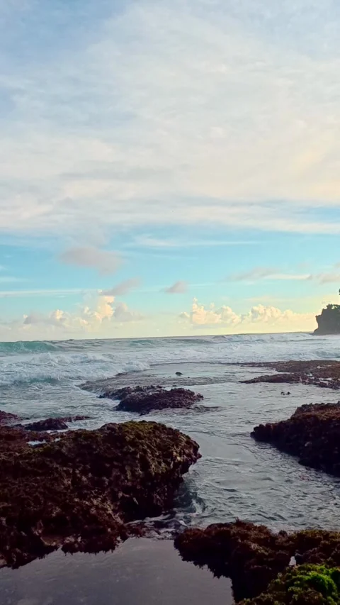 Vertical ocean view with rocks and blue sky Stock Footage 335442365