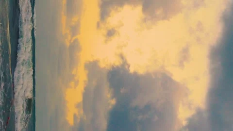 Vertical, Ocean Waves Yellow Sky with Srorm Black Gray Cumulus Clouds, Beautiful Stock Footage 306216870