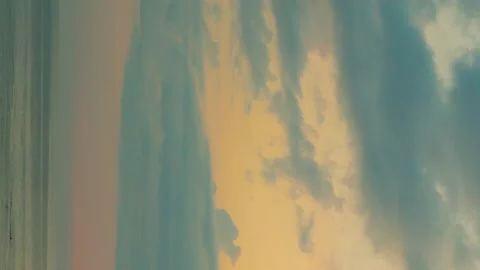 Vertical, Ocean Yellow Red Sunset Sky with Srorm Blue Gray Cumulus Clouds, Beaut Stock Footage 317542386