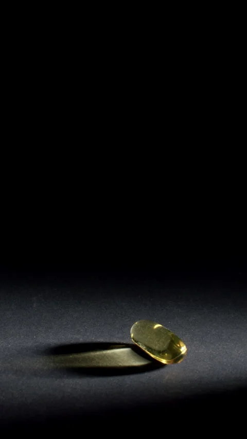 Vertical Omega 3 Capsule Macro with Negative Space Video stock 332369900